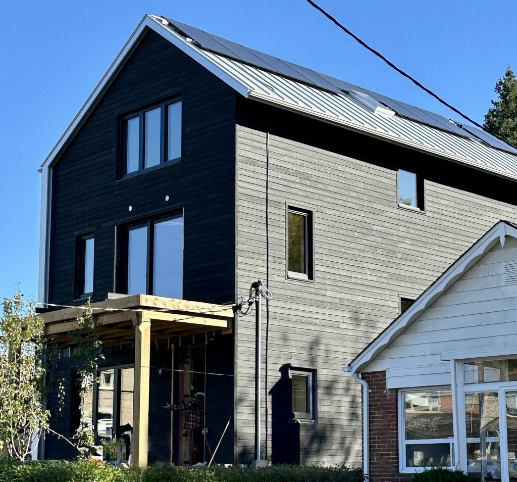 Unfinished exterior of the renovated home in the Caledonia-Fairbank neighbourhood. The house beside it is identical to what it was before the project began. Photo by Yvonne Bambrick.
